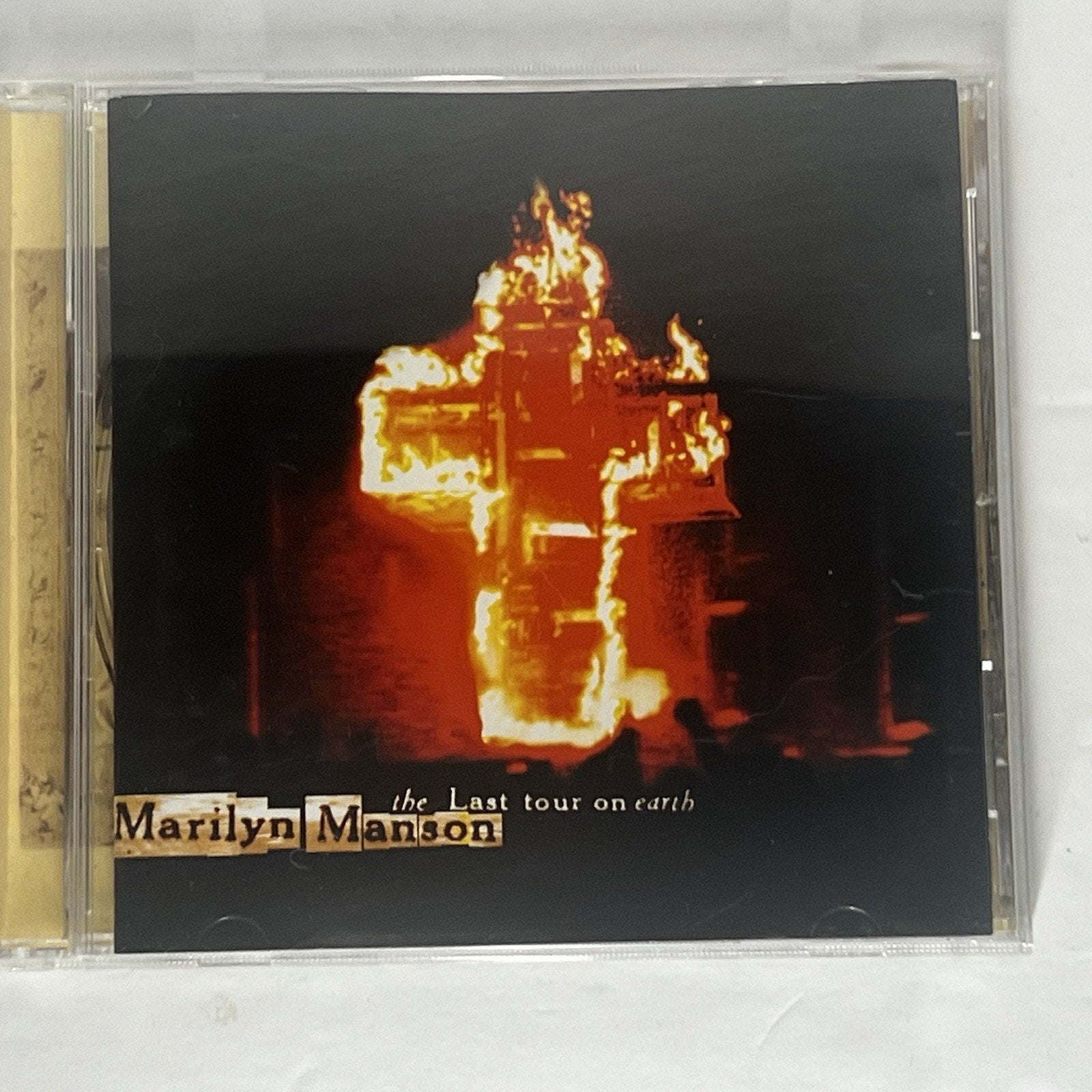 Marilyn Manson 'The Last Tour on Earth' CD album cover in a clear plastic jewel case, photographed on a white surface.